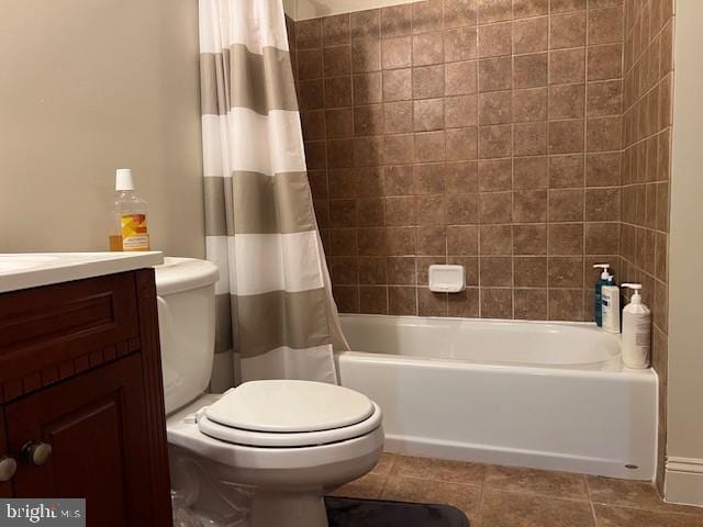 full bath featuring toilet, shower / bath combination with curtain, vanity, and tile patterned flooring