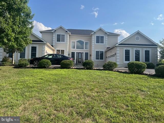 view of front of property with a garage and a front lawn