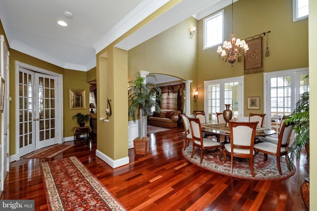 dining area with french doors, baseboards, wood finished floors, and ornamental molding