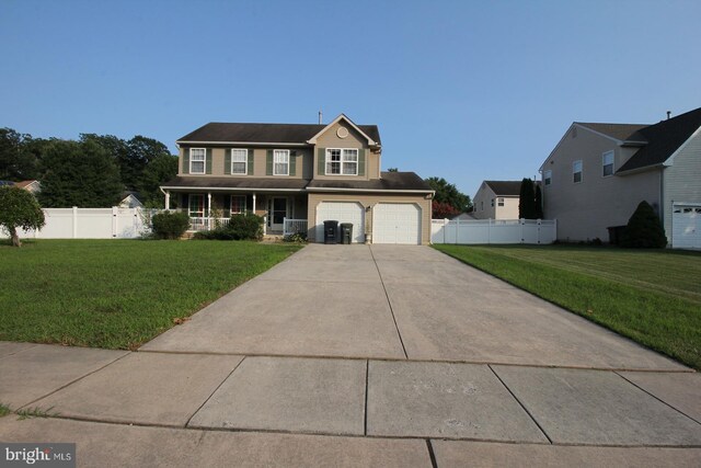 view of front of home featuring a front yard and a garage