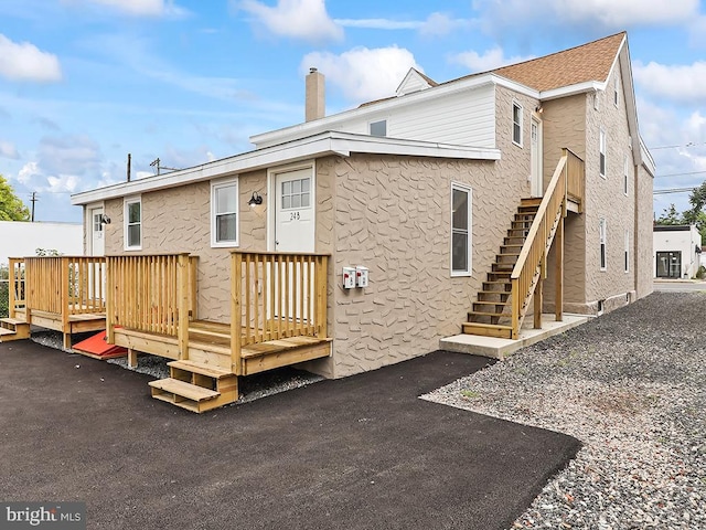 back of house featuring a patio and a deck