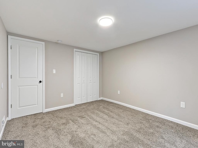 unfurnished bedroom featuring a closet and carpet