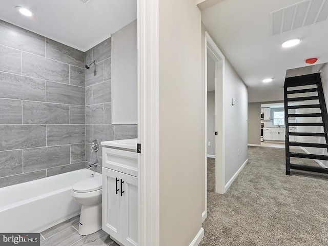 full bathroom with vanity, toilet, and tiled shower / bath