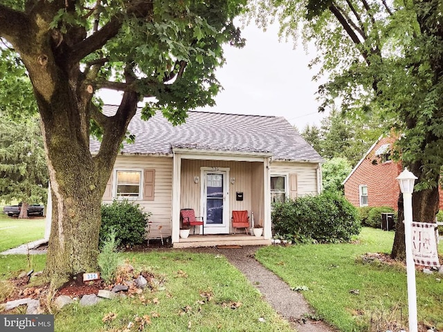 bungalow-style home featuring a front yard and a porch