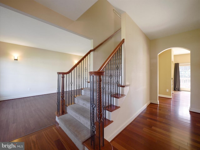 stairway with hardwood / wood-style floors