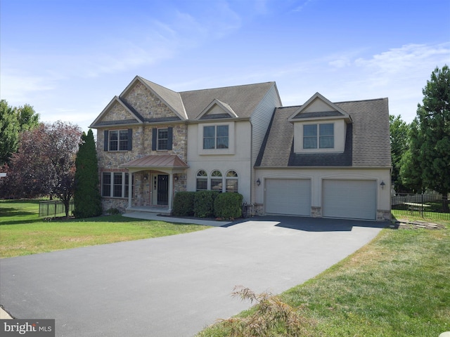 view of front of house featuring a garage and a front yard