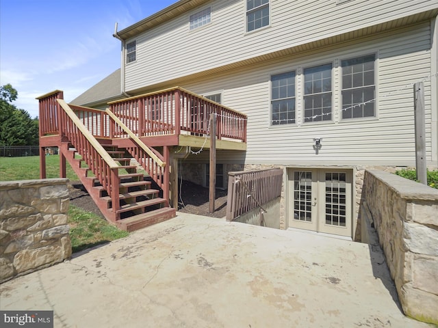 rear view of property featuring a patio, a deck, and french doors