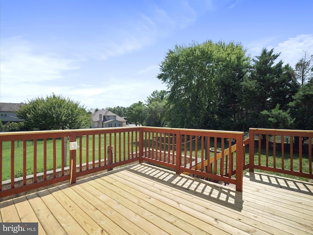 wooden terrace featuring a lawn