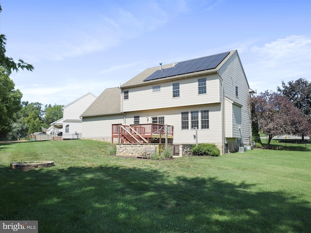 back of property featuring a yard and a deck