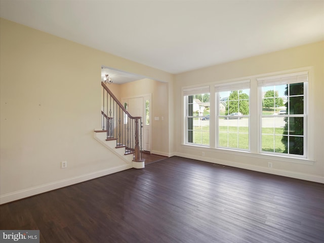 unfurnished living room with dark hardwood / wood-style floors