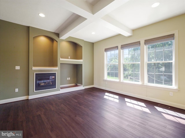 unfurnished living room with built in shelves, dark hardwood / wood-style flooring, and beamed ceiling