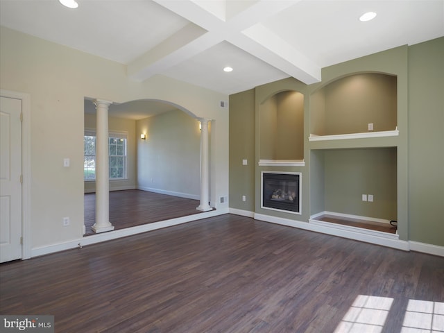 unfurnished living room with dark hardwood / wood-style flooring, beamed ceiling, and ornate columns