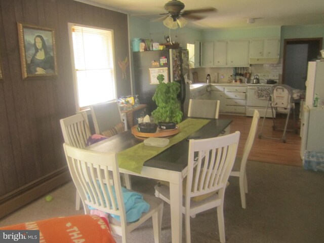 kitchen with wood-type flooring, tasteful backsplash, sink, white cabinetry, and white range with electric stovetop