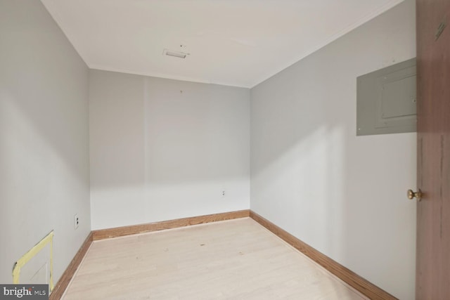 unfurnished room with light wood-type flooring and electric panel