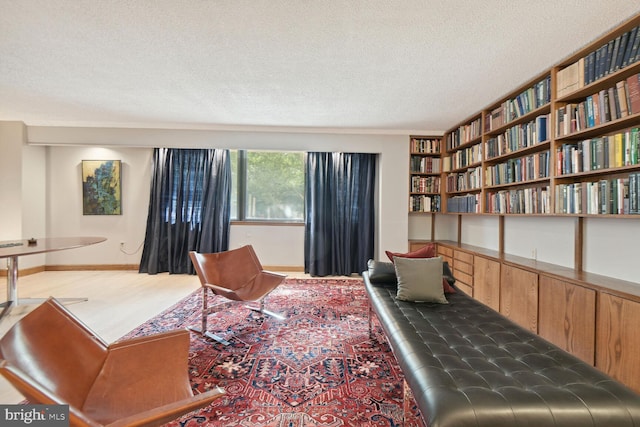 living area featuring a textured ceiling