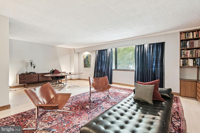 living room featuring a textured ceiling and light wood-type flooring