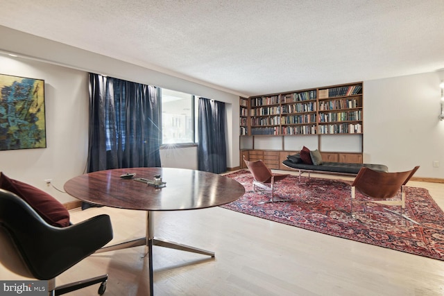 interior space featuring a textured ceiling and hardwood / wood-style flooring