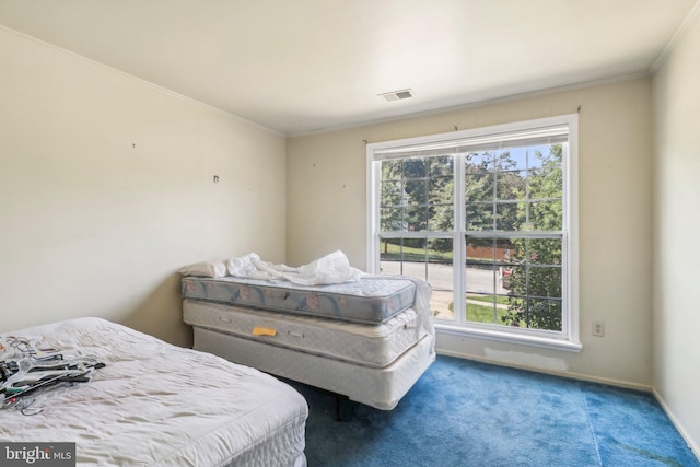 bedroom with multiple windows, carpet floors, and crown molding