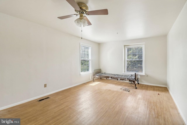 empty room featuring ceiling fan and light wood-type flooring