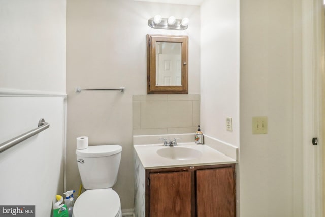 bathroom featuring toilet and vanity