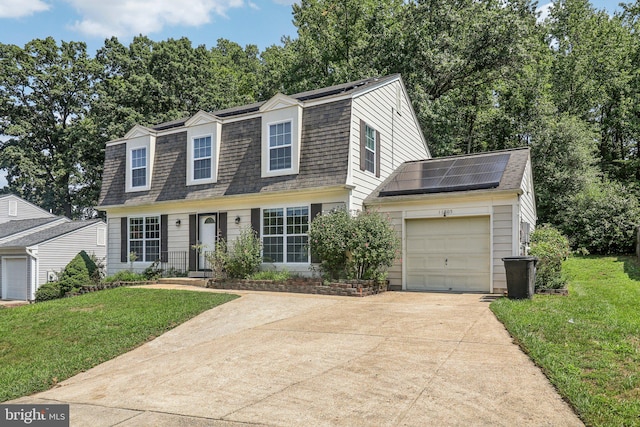 view of front facade featuring a front yard, solar panels, and a garage