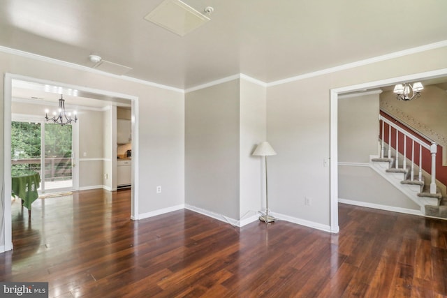 unfurnished room with an inviting chandelier, crown molding, and wood-type flooring