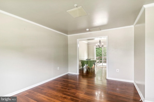 unfurnished room with wood-type flooring, ornamental molding, and a chandelier