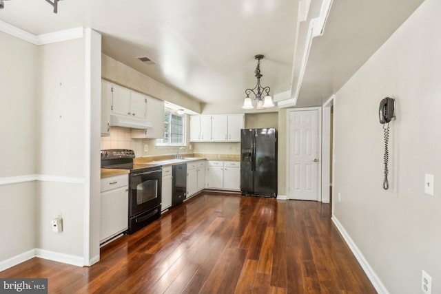 kitchen featuring decorative light fixtures, white cabinetry, tasteful backsplash, black appliances, and dark wood-type flooring