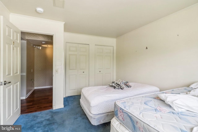 bedroom featuring a closet, carpet, and crown molding