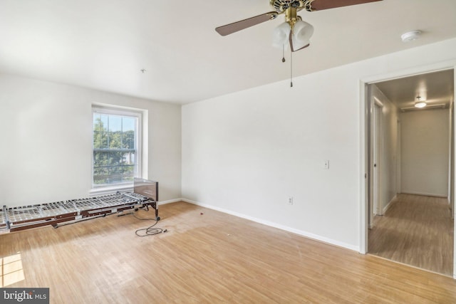 empty room featuring ceiling fan and light wood-type flooring