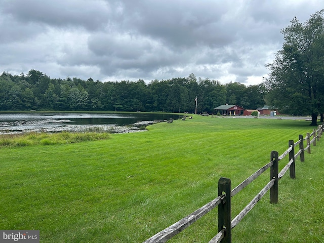 exterior space featuring a water view and a yard