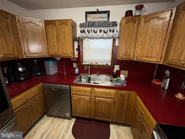 kitchen with sink, range, stainless steel dishwasher, and light hardwood / wood-style floors