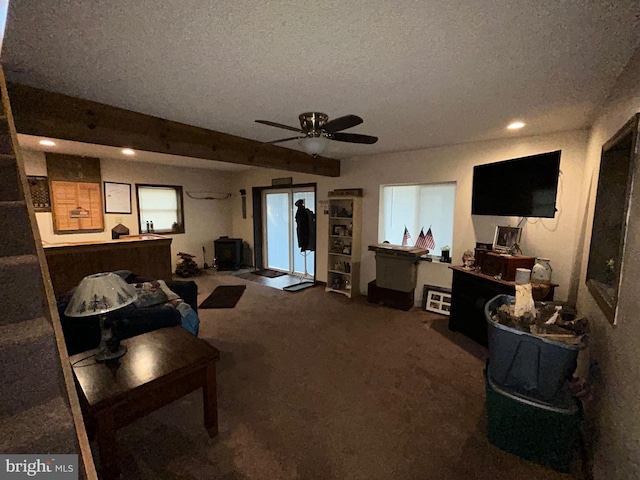 carpeted living room featuring a textured ceiling, beamed ceiling, and ceiling fan