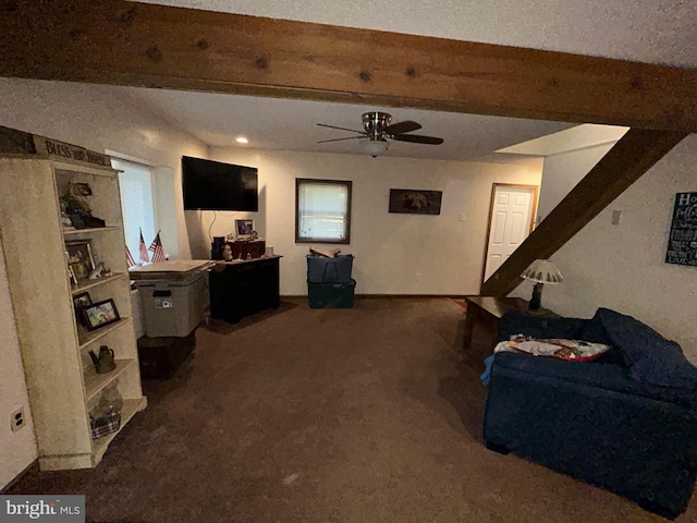 carpeted living room with ceiling fan and beam ceiling