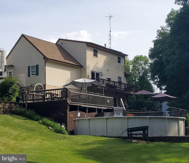 back of house featuring a deck and a yard