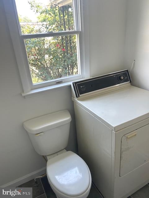 interior space featuring washer / clothes dryer and toilet