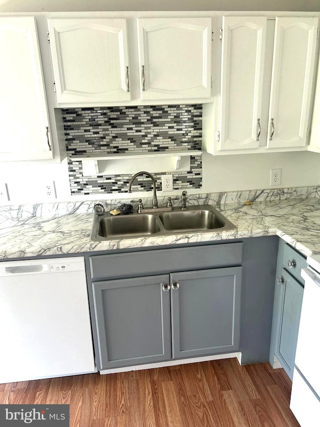 kitchen featuring white cabinetry, white appliances, dark hardwood / wood-style flooring, gray cabinets, and sink