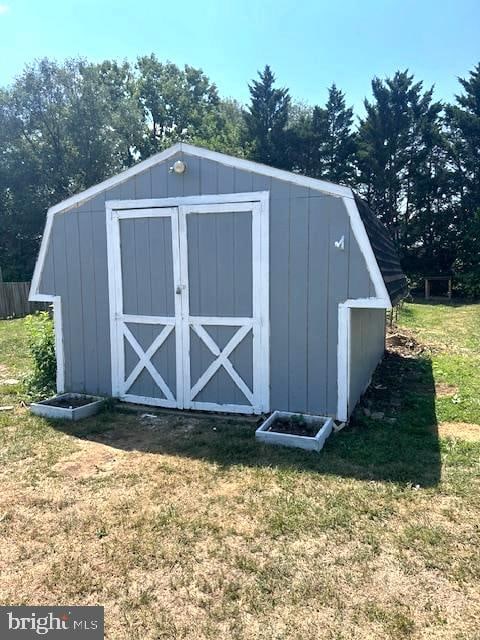 view of outdoor structure with a lawn