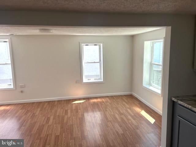 interior space featuring a textured ceiling and light wood-type flooring