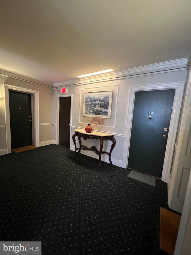 hall with baseboards, carpet, and ornamental molding