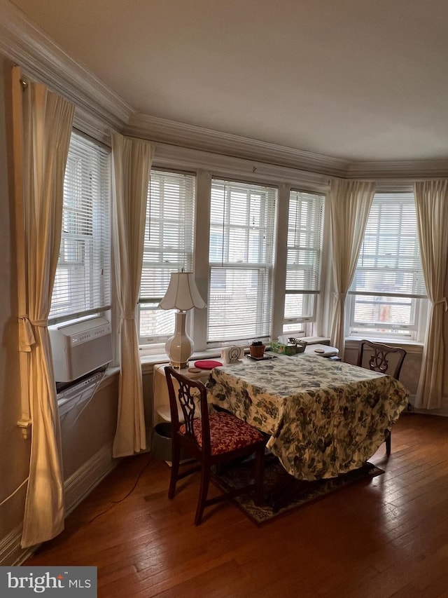 dining space featuring hardwood / wood-style floors, cooling unit, and ornamental molding