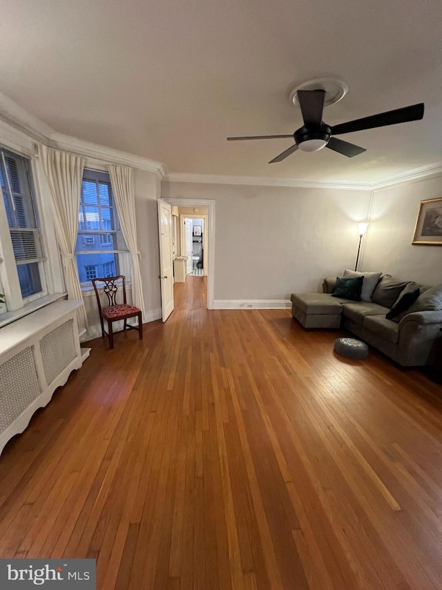 unfurnished room with radiator, crown molding, and hardwood / wood-style floors