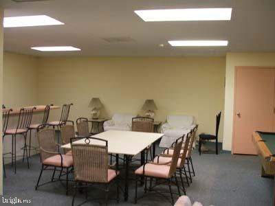 carpeted dining area with pool table