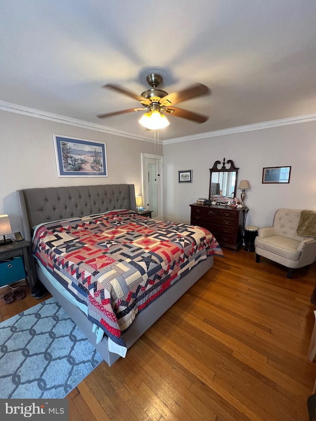 bedroom featuring ornamental molding, ceiling fan, and hardwood / wood-style flooring