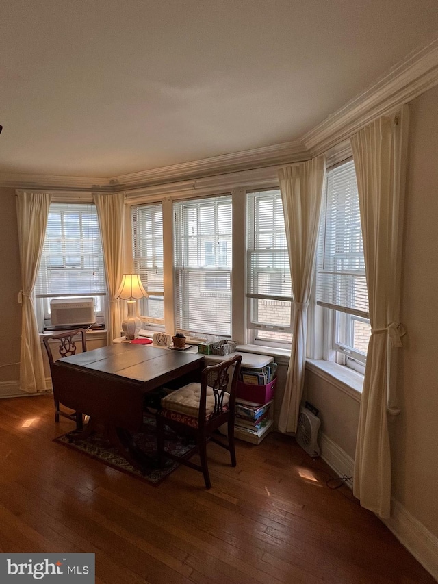 dining space featuring dark hardwood / wood-style floors, crown molding, and a wealth of natural light