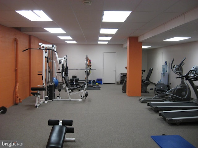 workout area with a paneled ceiling