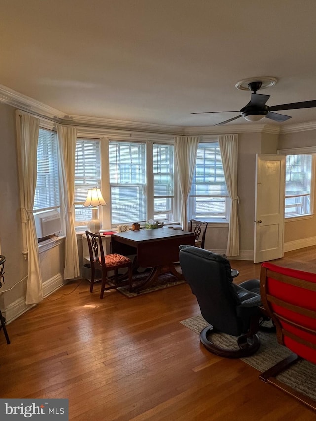 interior space featuring wood-type flooring, crown molding, and ceiling fan