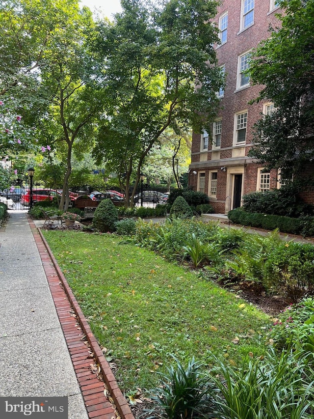 view of home's community featuring a lawn and fence