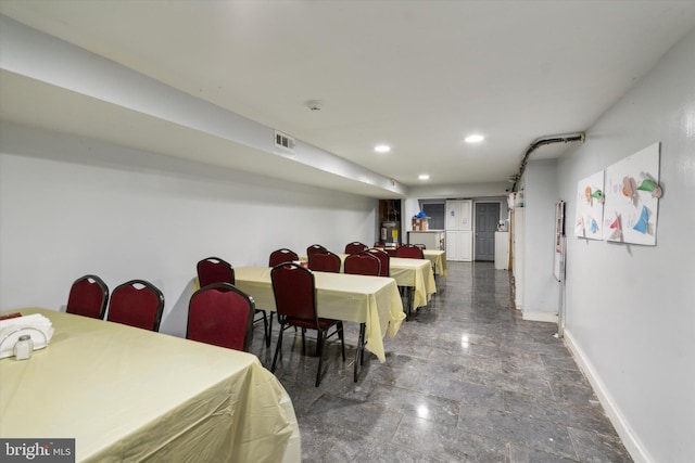 dining space featuring dark tile patterned floors