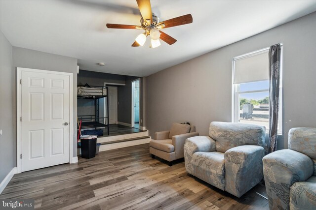 sitting room featuring hardwood / wood-style floors and ceiling fan